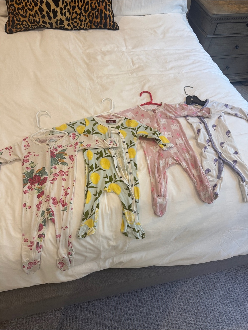 Four assorted sleeper onesies. Size 3 to 6 months.